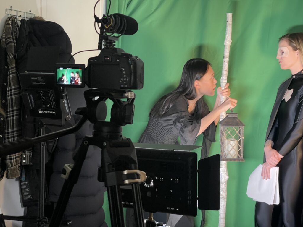 Behind the Scenes Picture, with two actors in front of a green screen